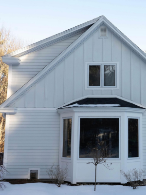 Nice white siding on a house in a winter setting.
